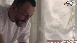 Kräftiger Masseur massiert den öligen Rücken der nackten Brünetten auf der Liege am hellen Fenster